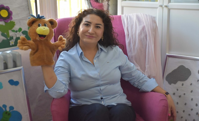Pembe koltukta anlattığı masallarla öğrencilerin kaygılarını aşmasına destek oluyor